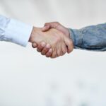 Cropped shot of two businesspeople shaking hands.