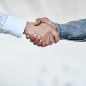 Cropped shot of two businesspeople shaking hands.
